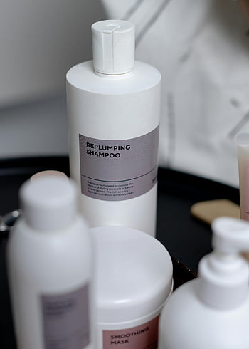 white bottle, replumping shampoo, haircare, cosmetics, black tray, smoothing mask, hair product, beauty product, skincare, white container, hair treatment