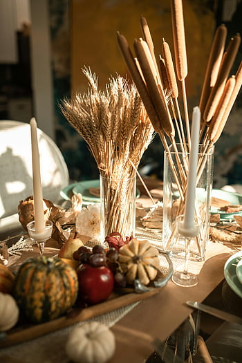 Thanksgiving table setting, fall table decor, candles, gourds, wheat, festive atmosphere, autumn table arrangement, harvest table, seasonal decor, thanksgiving decorations, thanksgiving centerpiece