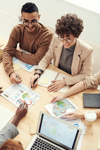 professionals meeting, diverse team, business meeting, charts and graphs, collaboration, office setting, workplace discussion, team collaboration, professional discussion, meeting room, business professionals