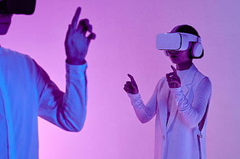 VR headsets, two adults, vibrant lighting, futuristic technology, studio setting, virtual reality, neon colors, interactive experience, modern technology, immersive gaming, VR gaming