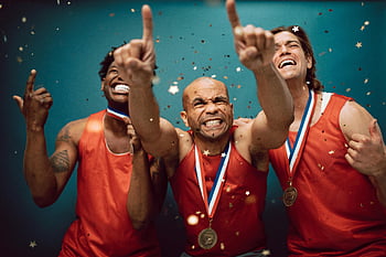 athletes wearing medals, celebrating victory, medals, confetti, blue background, three athletes, sports victory, athletic achievement, medal winners, confetti celebration, sports celebration