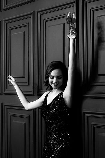 happy lady, dress, raised hands, wineglass, elegant woman, glamorous dress, celebrates joyfully, stylish room, black and white, celebration, elegance