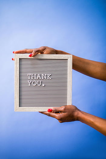 thank you sign, hands holding sign, blue backdrop, social media content, digital marketing image, gratitude message, letterboard sign, thank you board, thank you message, red nails, blue background