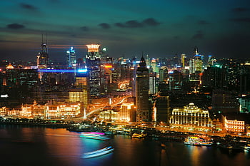 Shanghai skyline, night view, illuminated city, waterfront cityscape, aerial view, urban landscape, city lights, modern skyscrapers, riverfront view, vibrant city, Shanghai waterfront