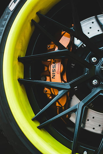 car wheel, brake disc, high-performance design, vibrant close-up, sporty car, yellow rim, brake caliper, Nissan, Brembo, car brake, wheel showcase