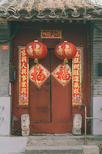 Chinese lanterns, red door, festive decorations, New Year celebration, traditional door, Chinese New Year, red Chinese lanterns, festive posters, Chinese culture, holiday decorations, red and gold