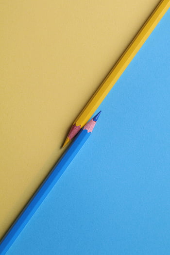 yellow colored pencils, blue colored pencils, vibrant colors, contrasting backgrounds, close-up photography, art supplies, stationery, creative tools, minimalistic design, color pencils, paper backgrounds