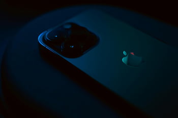 Apple iPhone Pro, back of iPhone, camera lenses, sleek design, dark lighting, close-up smartphone, Apple logo, modern technology, high-end device, mobile photography, premium phone