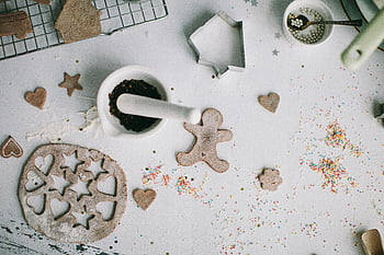 gingerbread cookies, cookie cutters, sprinkles, overhead view, gingerbread preparation, baking, festive, holiday, cutout gingerbread, mortar and pestle, heart shapes