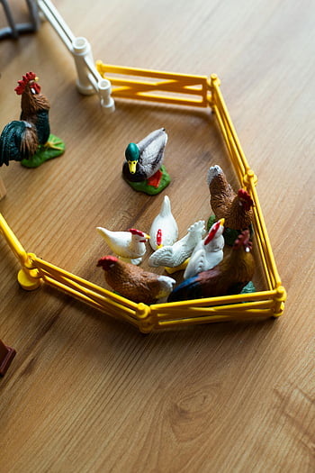 plastic toy farm animals, yellow playset, kids' imaginary play, toy chickens, toy duck, toy rooster, farm animal figurines, children's toys, playset animals, farm toys, toy farm set