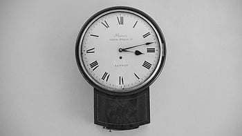 antique wall clock, roman numerals, classic design, black and white image, analog watch, round clock, vintage timepiece, wall-mounted clock, antique clock, classic analog clock, black analog watch
