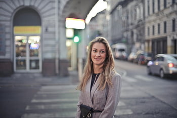woman in gray suit jacket, gray car, urban Budapest, evening lights, street scene, confident smile, city life, evening urban scene, professional woman, street fashion, vibrant lights