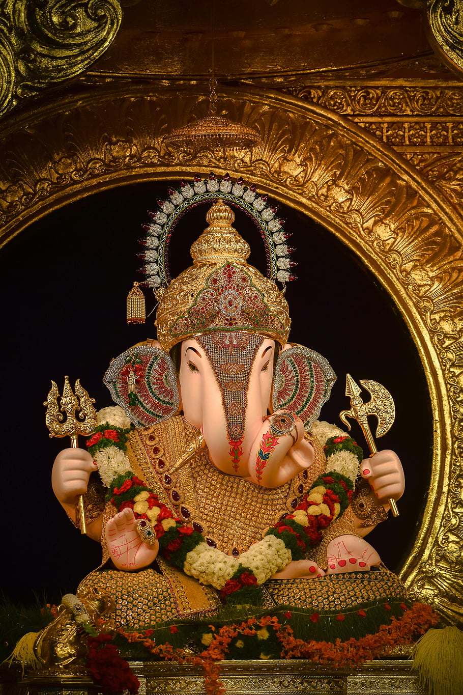 Ganesh idol, Dagadusheth Halwai Ganapati Temple, Pune City, India, beautifully adorned, rich cultural artistry, religious artistry, temple, cultural heritage, ornate decoration, floral garlands