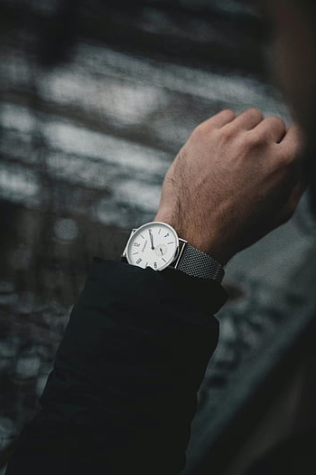 round analog watch, stylish wristwatch, man's wrist, timeless elegance, fashion, analog clock, elegant watch, wrist accessory, classic watch, men's fashion, silver watch
