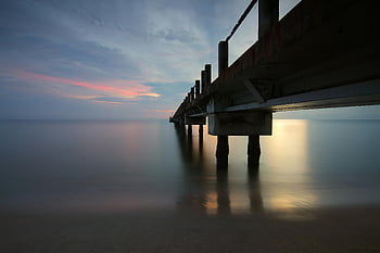 sunset, sea, pier, scenic view, tranquil scene, reflective sea, sunset photography, beach sunset, ocean sunset, long exposure, sunset pier