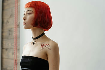 woman in black tube top, red hair, shoulder tattoo, studio portrait, fashionable woman, studio setting, black choker, red hair woman, shoulder tattoo woman, studio photography, black tube top