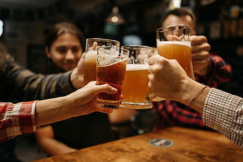 friends drinking beer, celebratory toast, beer mugs, indoor celebration, fun and friendship, group of friends, beer glasses, social gathering, indoor party, toasting beer, friendly celebration