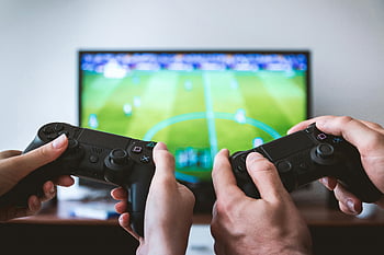 gaming controllers, black gaming consoles, video gaming session, hands holding controllers, close-up gaming, TV screen, engaged gamers, multiplayer gaming, gaming setup, video game controllers, gaming experience