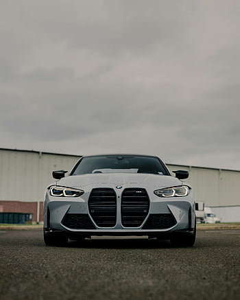 BMW M3, luxury sedan, front view, outdoor parking, cloudy sky, asphalt road, BMW car, modern vehicle, high-performance car, automotive design, luxury vehicle