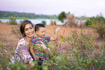 mujer abrazando chico, Feliz madre e hijo, día al aire libre, pintoresco campo, campo, madre e hijo, entorno natural, momento familiar, escena rural, madre sonriente, niño jugando