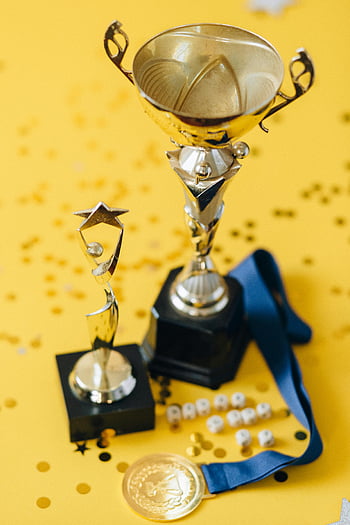 gold trophy, silver trophy, yellow textile, confetti, medal, award, celebration, golden trophies, yellow background, blue ribbon, star award
