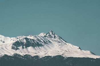 snow-capped mountain, clear blue sky, winter landscape, breathtaking view, mountain peak, snow-covered, winter scenery, mountain range, alpine view, winter mountain, clear sky
