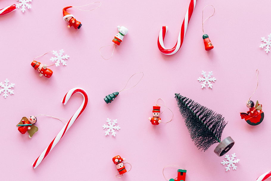 Christmas decorations, candy canes, snowflakes, pink background, holiday celebrations, colorful ornaments, festive design, Christmas ornaments, candy cane decorations, snowflake ornaments, Christmas tree decorations