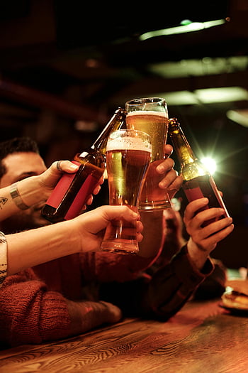 friends toasting, beer bottles, beer glasses, cozy bar, celebrating together, group cheers, social gathering, bar setting, beer celebration, friendly toast, nightlife scene