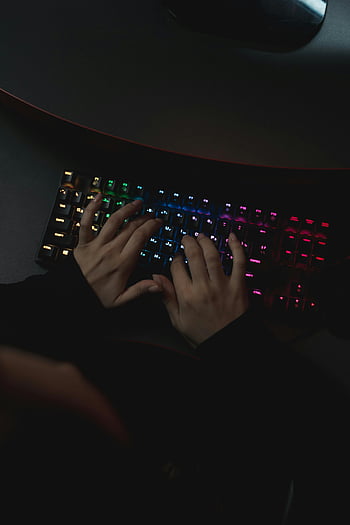 person typing, keyboard, colorful backlit, mechanical keyboard, dark setting, hands, computer, gaming, workspace, technology, night