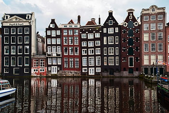 Amsterdam houses, canal reflection, iconic architecture, red buildings, brown buildings, picturesque row, water reflection, Amsterdam canal, historic houses, Dutch architecture, canal houses