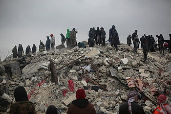collapsed building, rubble, survivors, rescuers, disaster, Idlib, Syria, search and rescue, earthquake aftermath, humanitarian aid, emergency response