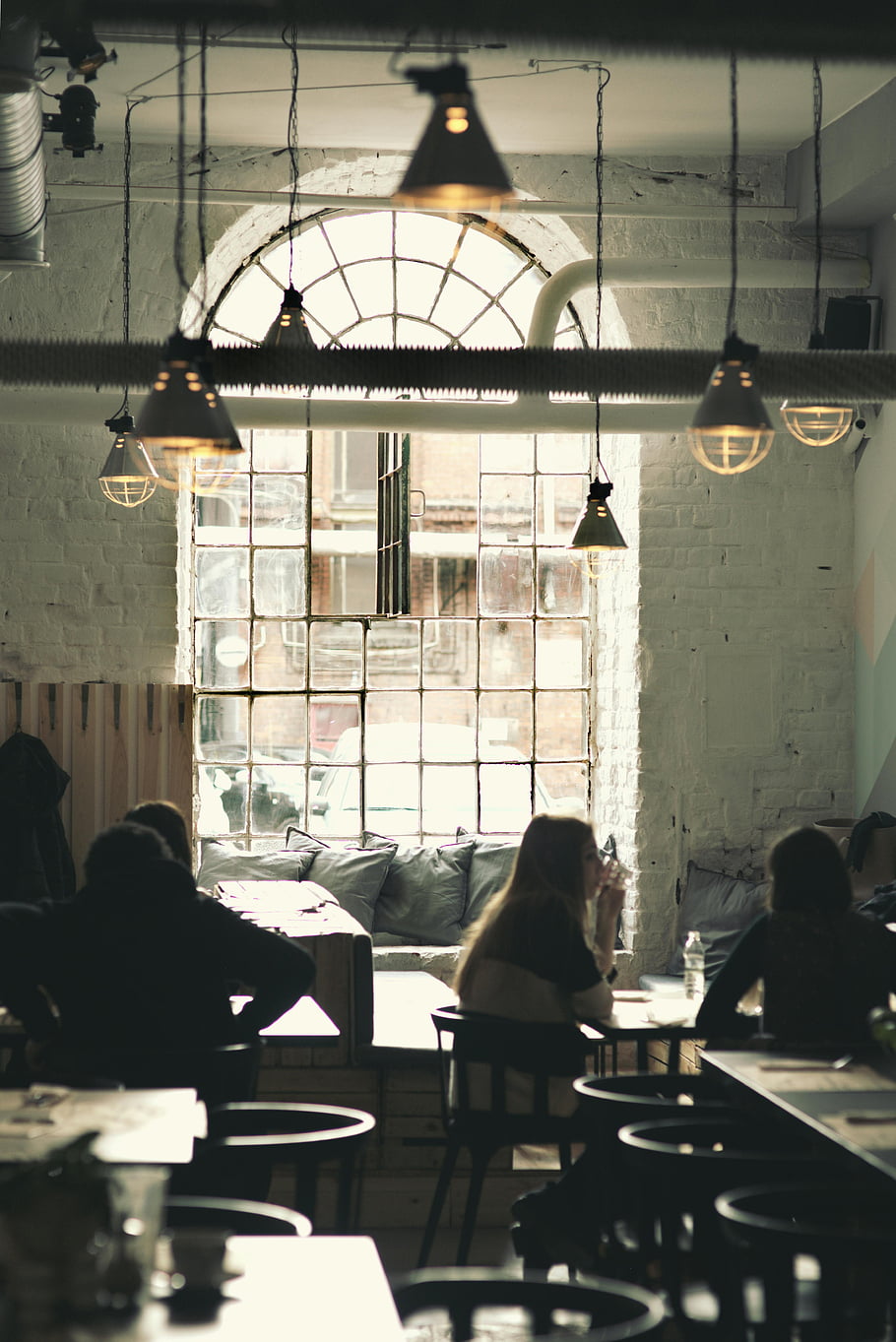vintage restaurant, cafe interior, vintage decor, soft lighting, people conversing, warm ambiance, inviting atmosphere, interior design, cafe setting, vintage style, cozy cafe