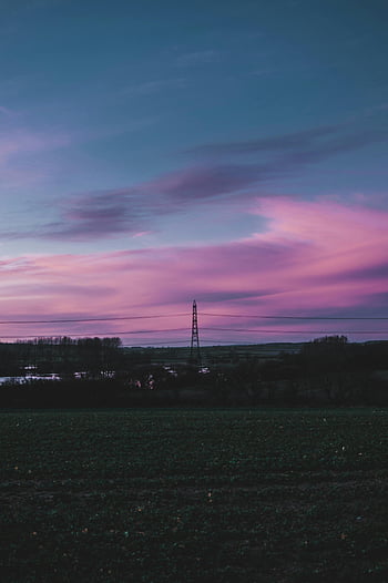 sunset sky, rural landscape, silhouette pylon, vibrant pink, blue sky, captivating scene, evening view, natural beauty, countryside scenery, power lines, dusk colors