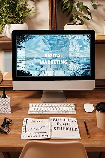 business plan schedule, digital marketing strategy, contemporary office setup, computer screen, notebook, business technology themes, digital marketing, office desk, keyboard, mouse, plants