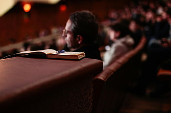 pen and notebook, auditorium, blurred audience, focused shot, notebook, pen, lecture hall, audience, classroom, study, writing