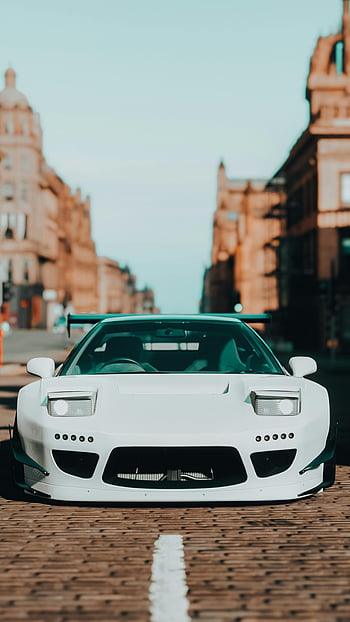Honda NSX bianca, auto sportiva, parcheggiata, strada di ciottoli, paesaggio urbano, vista frontale, design elegante, contesto urbano, macchina bianca, via della città, honda nsx