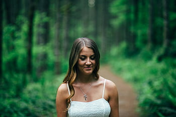 woman, smiling, white spaghetti strap top, lush green forest, tranquility, focus photography, peaceful, white dress, standing, nature, serene