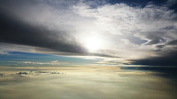 sea clouds, daytime photography, sunlight, dramatic clouds, serene cloudscape, sky view, natural light, cloud formation, atmospheric beauty, landscape photography, cloud photography