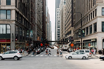White Sedan, dynamic cityscape, pedestrians, skyscrapers, vehicles, urban scene, city street, crosswalk, traffic, modern city, street view