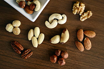brown nuts, wooden panel, high-angle photo, healthy snacking, various nuts, close-up, wooden table, cashews, almonds, walnuts, pecans