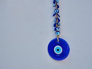 blue hanging ornament, evil eye charm, protection, good luck, white background, blue evil eye, hanging decoration, ornamental charm, lucky charm, wall hanging, decorative item