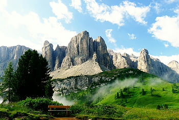 Gray Stone Mountain, near tree, idyllic mountain landscape, lush greenery, dramatic clouds, mountain scenery, natural beauty, outdoor view, scenic mountain, green landscape, mountain view