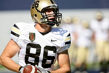 college football player, uniform, holding football, game, focused player, sports, football, athlete, helmet, action shot, competition