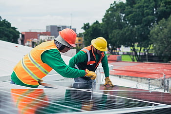 solar technicians, installing solar panels, rooftop solar panels, workers with PPE, safety equipment, construction tools, renewable energy, solar energy, green technology, sustainable energy, solar panel installation