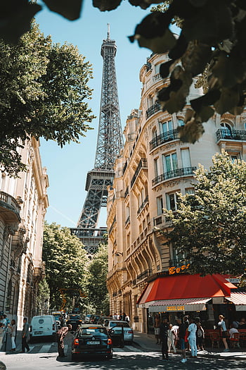 Eiffel Tower, Paris street, bustling cafes, people, picturesque scene, Paris buildings, street scene, urban view, French architecture, outdoor cafes, city life