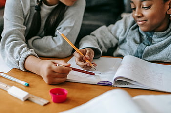 kids doing homework, studying together, focused homework, pencils and notebooks, learning indoors, children studying, homework time, educational activities, kids education, indoor learning, collaborative learning