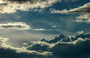 gray nimbus clouds, low angle photography, dramatic cloudscape, layered clouds, sunlight breaking through, captivating sky scene, sky photography, cloud photography, natural sky, atmospheric photography, cloud formations