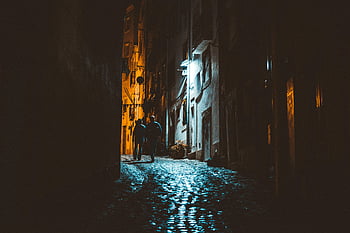 night alley, cobblestone street, dramatic lighting, silhouettes, walking people, narrow alley, urban night scene, city nightlife, street photography, night photography, urban exploration