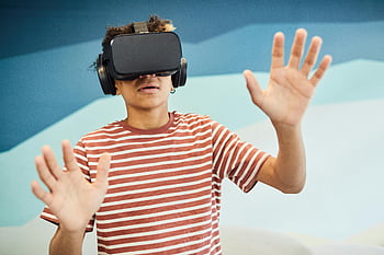 VR headset, virtual reality, amazed boy, teen boy, striped shirt, fully immersed, indoor exploration, virtual reality experience, interactive technology, gaming technology, futuristic entertainment