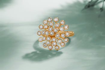 gold ring, diamonds, close-up shot, luxury jewelry, teal background, elegant design, diamond ring, gold jewelry, high-end accessories, fine jewelry, diamond cluster